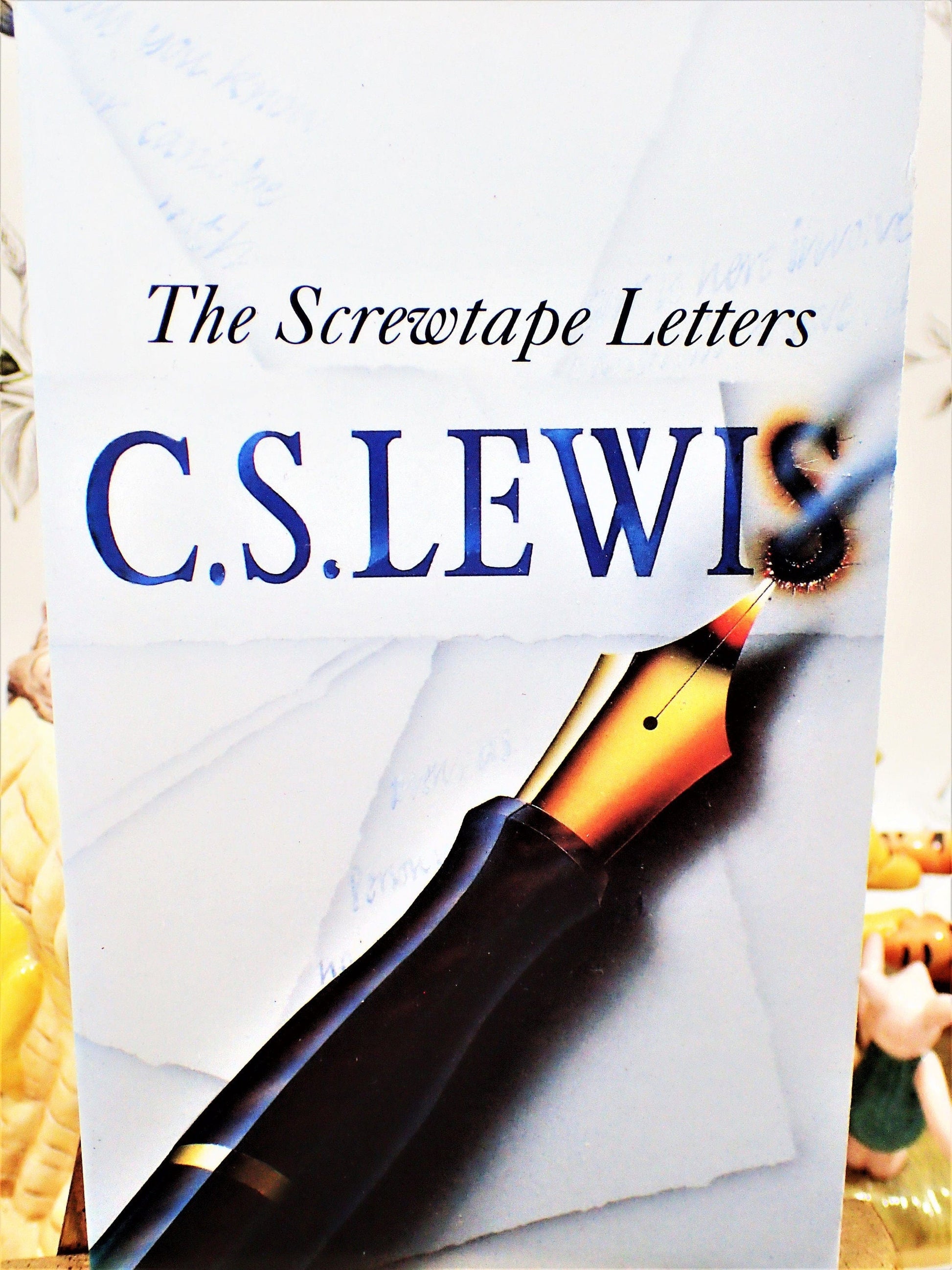 Front cover of The Screwtape Letters C S Lewis Vintage Paperback Book 1970's showing a pen with its ink burning through the paper. 
