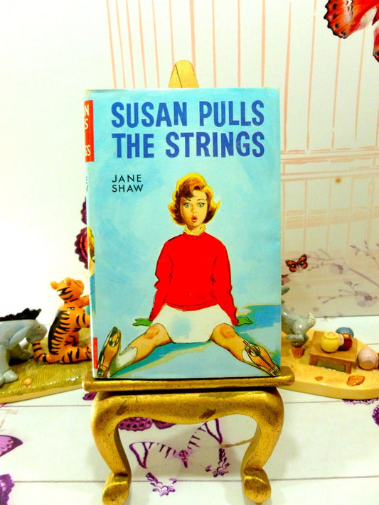 Front cover of Susan Pulls the Strings by Jane Shaw Vintage Hardback book with DW Susan Stories The Childrens Press 1960's.