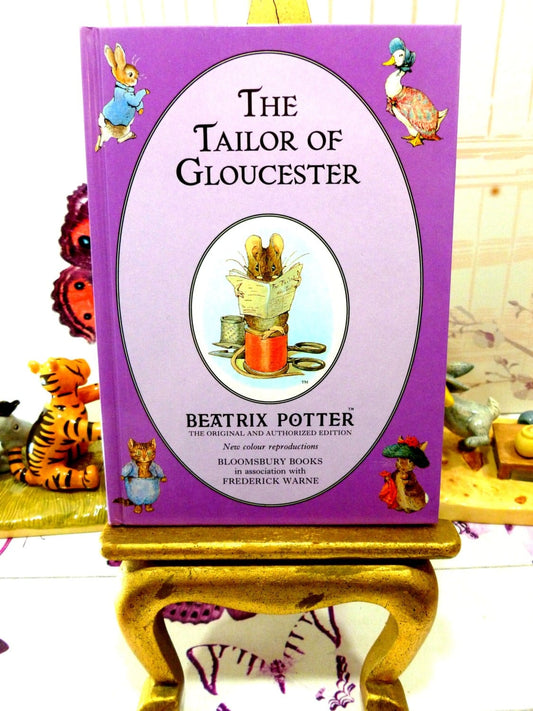 Front cover of The Tailor of Gloucester First Edition Purple Bloomsbury Book 1993 Beatrix Potter Childrens Story showing Beatrix Potter characters on a purple ground.