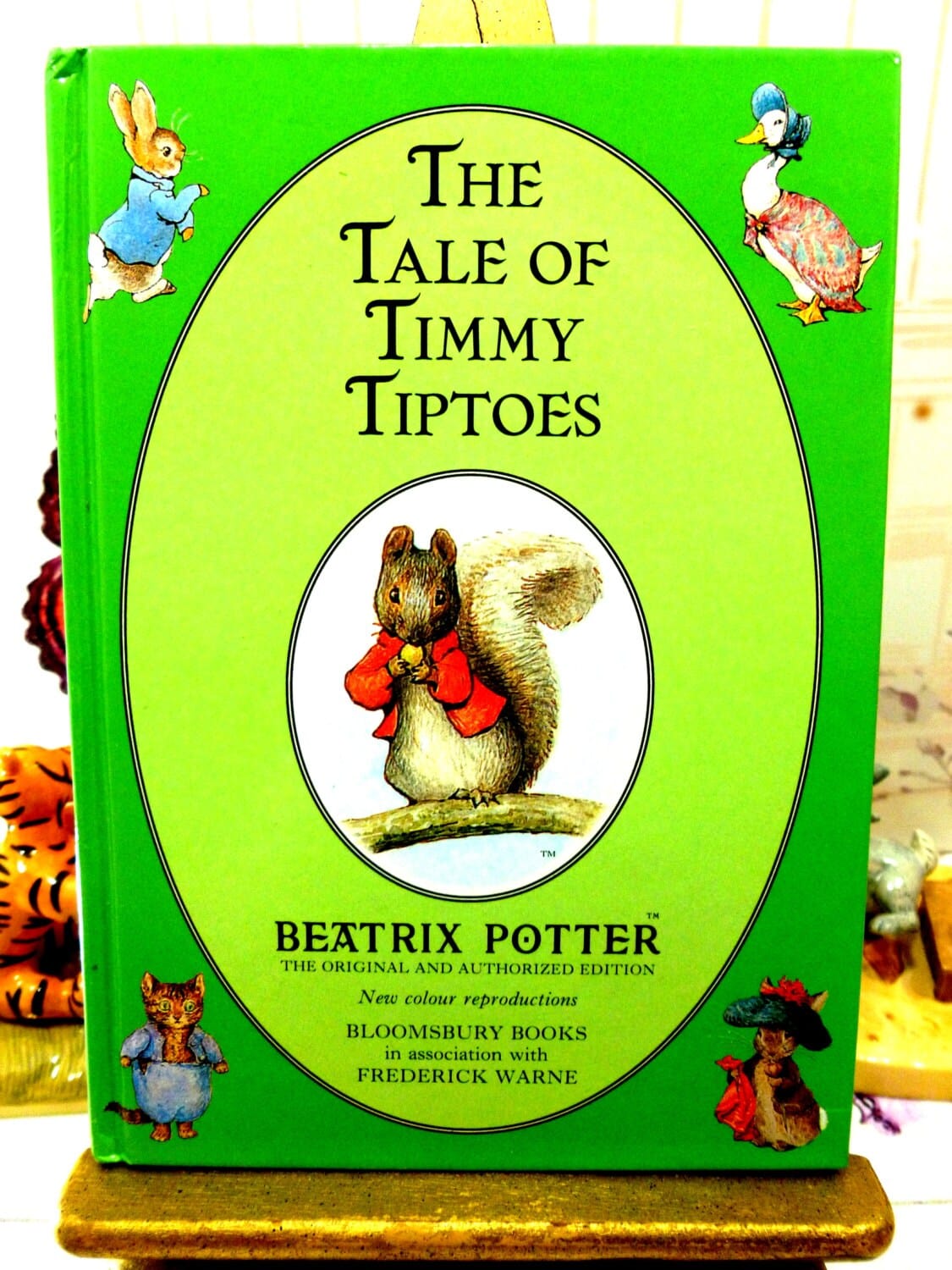 Front cover of The Tale of Timmy Tiptoes First Edition Bloomsbury Book 1993 with Timmy Tiptoes Squirrel cameo and other Beatrix Potter characters. 