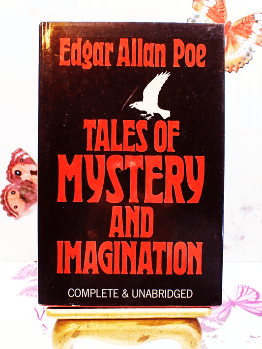 Front cover of Tales of Mystery and Imagination Edgar Allan Poe Vintage Book 1980's showing a white raven and scarlet red titles against a black ground. 