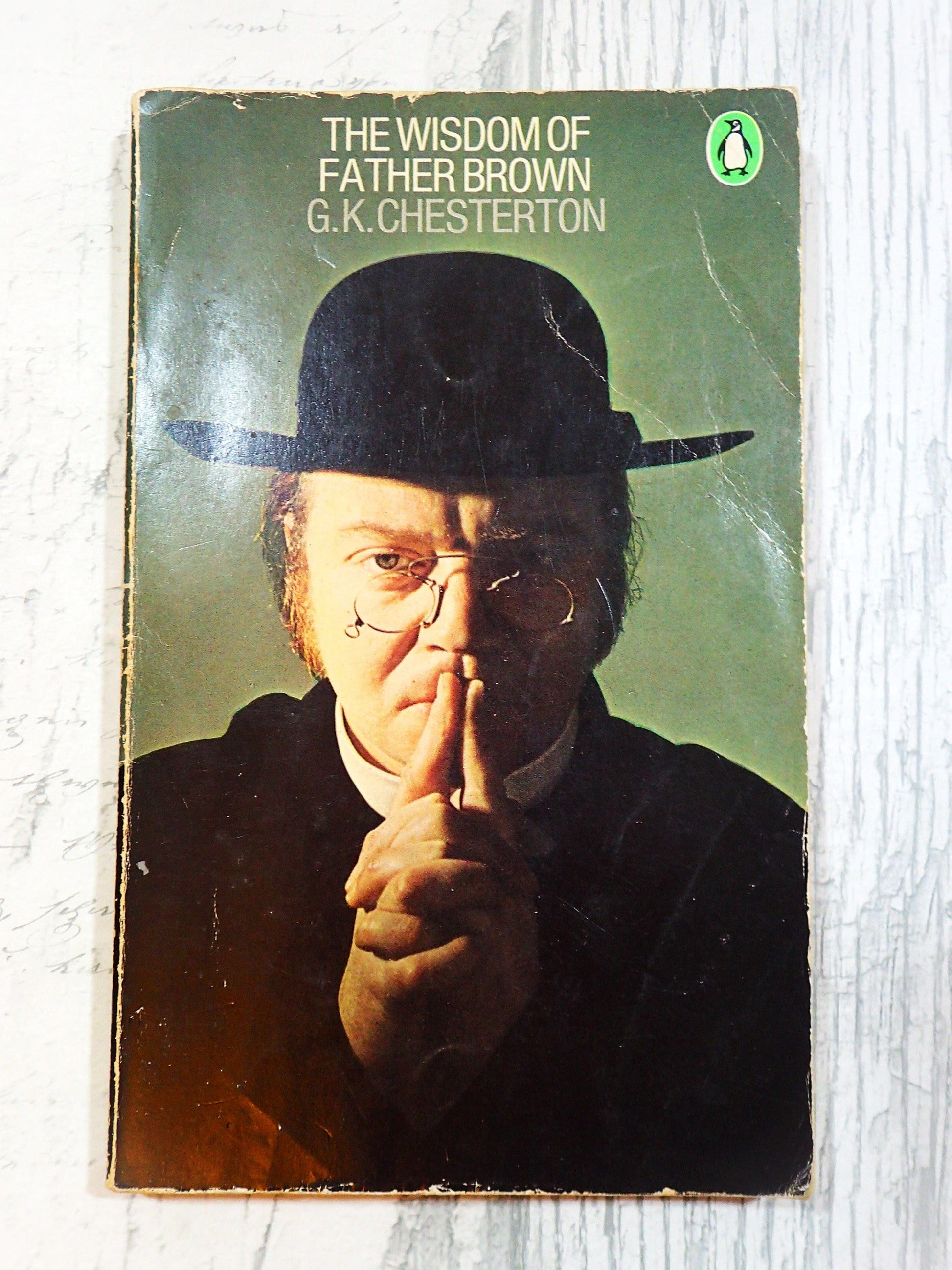 Front cover of Vintage Penguin Paperback The Wisdom of Father Brown showing a man wearing a dog collar, round spectacles and hat against a light background.  