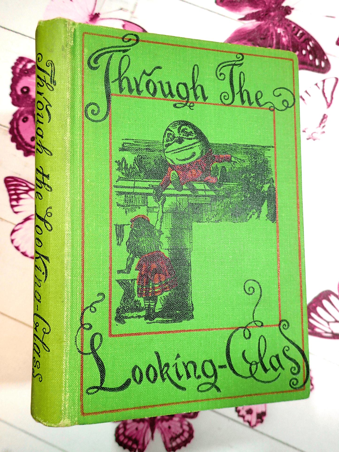 Spine and Front cover in green with black and red design of Through the Looking Glass Lewis Carroll