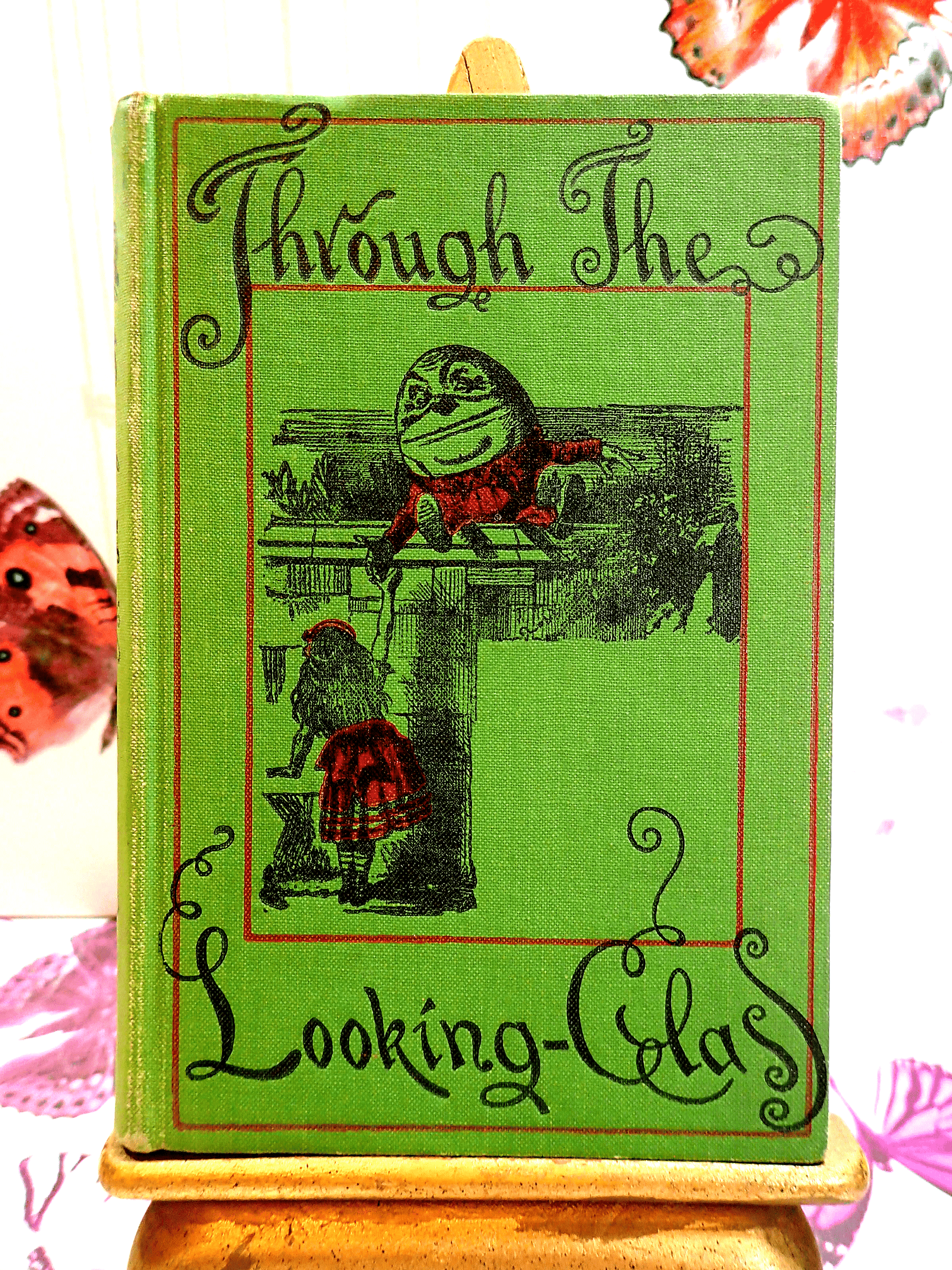 Front cover of Through the Looking Glass Lewis Carroll showing Alice and Humpty Dumpty