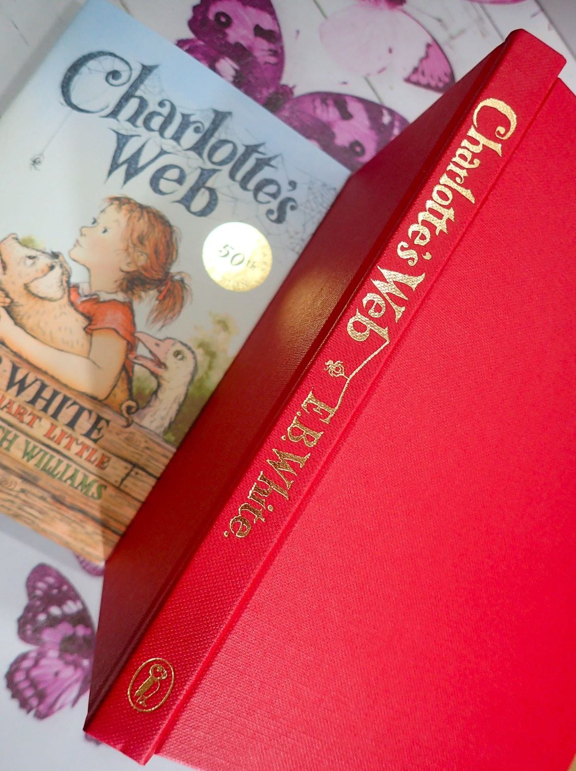 Red Binding and gilt titles of Vintage Children's Book Charlotte's Web by E. B. White Puffin 50th Anniversary Edition. 
